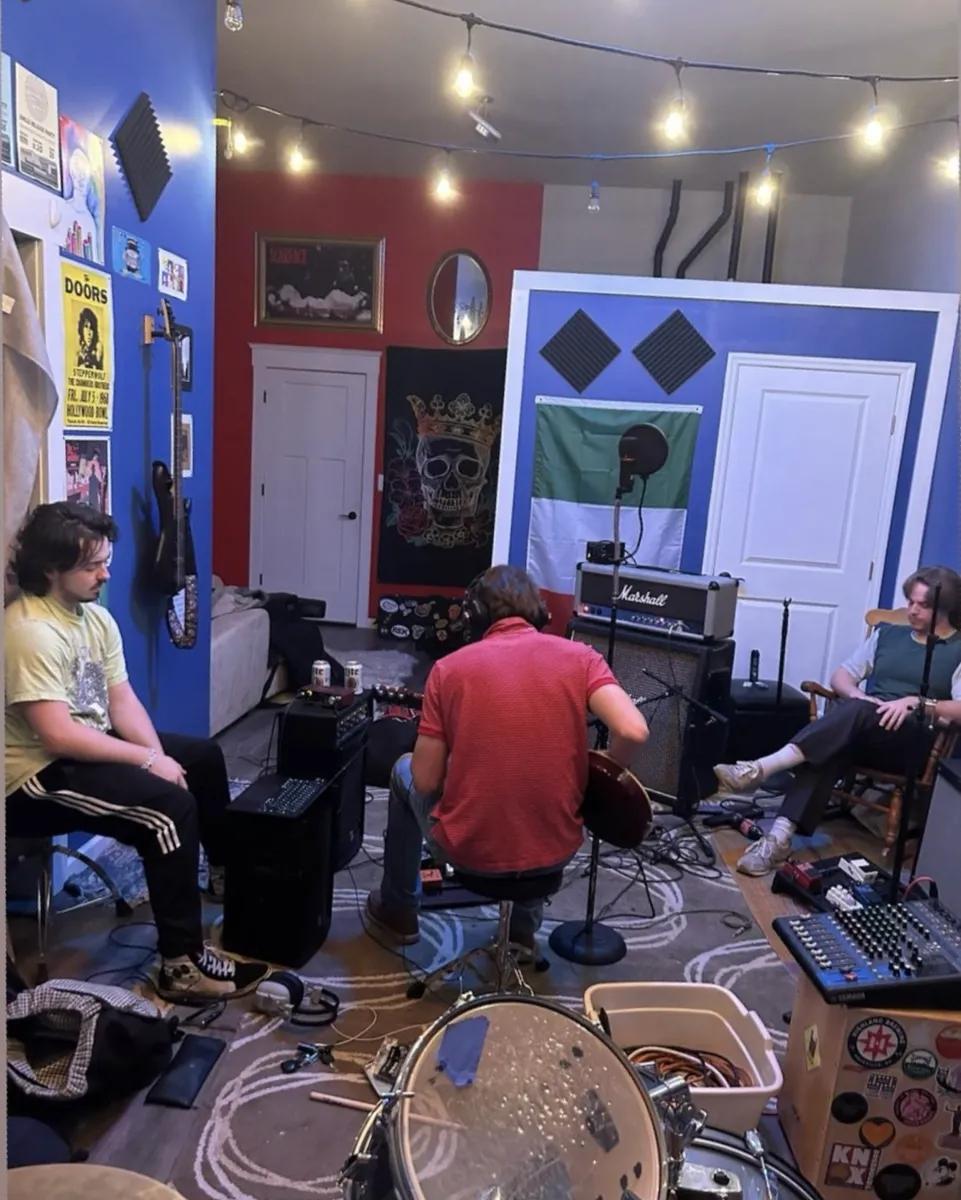 Gus recording bass tracks with vocals.
